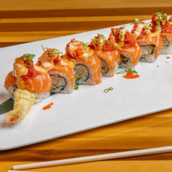 Nara Sushi Ramen's salmon sushi rolls with tempura shrimp, sauce, and roe on a white plate.