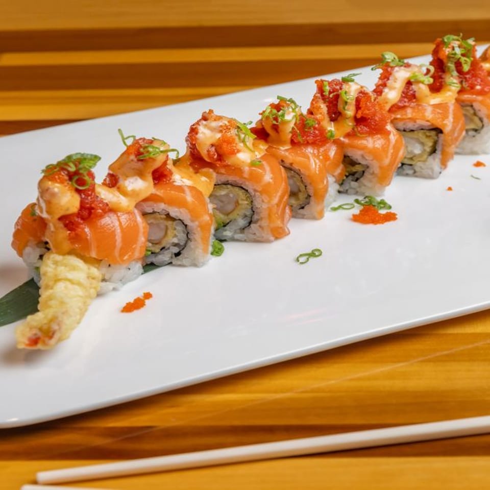 Nara Sushi Ramen's salmon sushi rolls with tempura shrimp, sauce, and roe on a white plate.